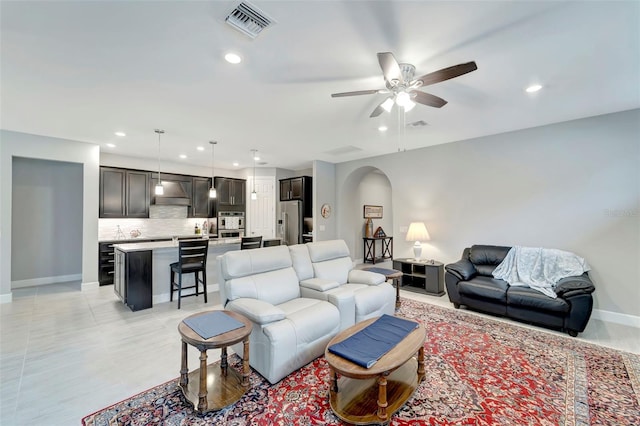 tiled living room with ceiling fan