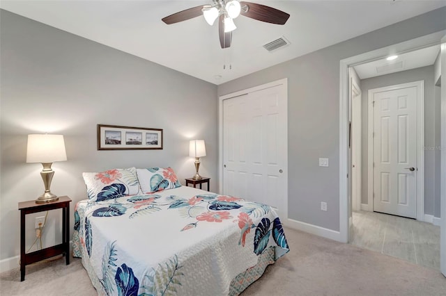 carpeted bedroom featuring a closet and ceiling fan