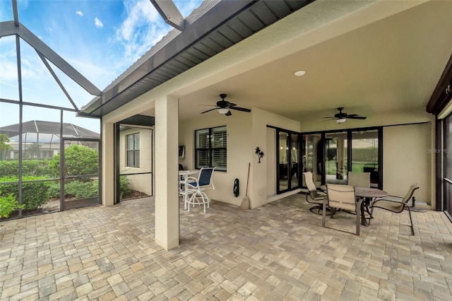 view of patio featuring a lanai and ceiling fan