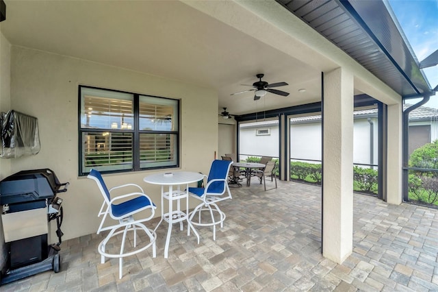 view of patio featuring ceiling fan and a grill