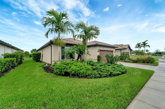 view of property exterior with a garage and a yard