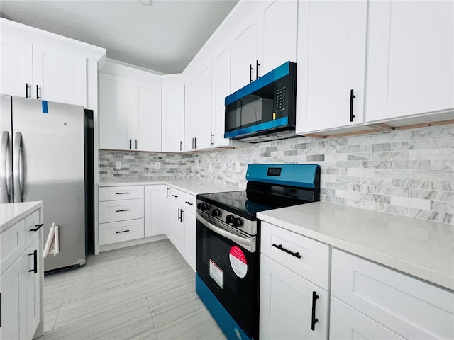 kitchen with appliances with stainless steel finishes, light tile patterned flooring, tasteful backsplash, and white cabinetry