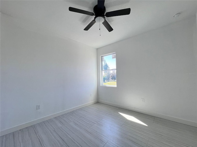 spare room with ceiling fan and light hardwood / wood-style flooring