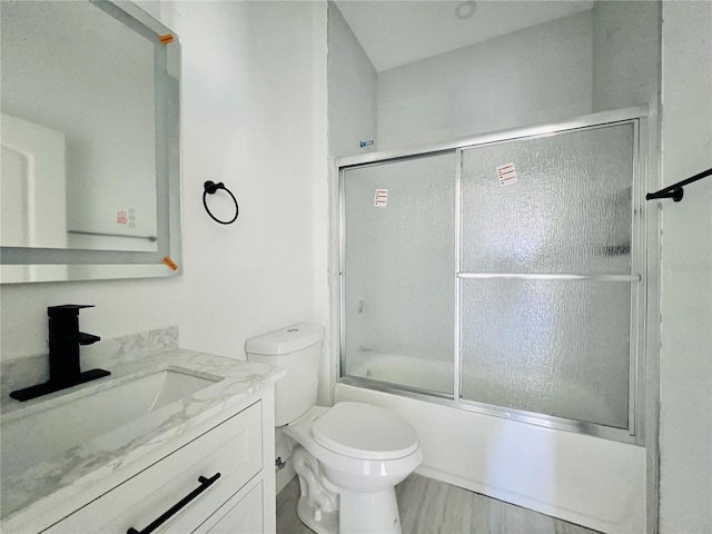 full bathroom with toilet, vanity, and combined bath / shower with glass door