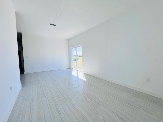 empty room featuring a tile fireplace