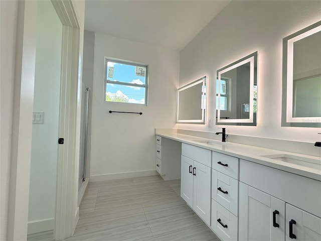 26345 Trinilas Dr, Punta Gorda, FL 33983 - full bath featuring a shower stall, double vanity, baseboards, and a sink