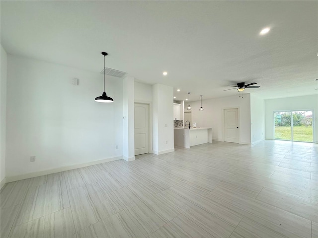 26345 Trinilas Dr, Punta Gorda, FL 33983 - unfurnished living room featuring recessed lighting, baseboards, a sink, visible vents, and a ceiling fan