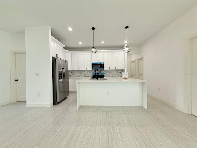 26345 Trinilas Dr, Punta Gorda, FL 33983 - kitchen with light countertops, white cabinets, tasteful backsplash, a sink, and stainless steel refrigerator with ice dispenser