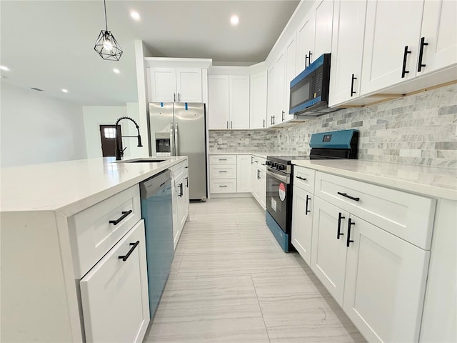 26345 Trinilas Dr, Punta Gorda, FL 33983 - kitchen featuring decorative light fixtures, stainless steel appliances, decorative backsplash, a sink, and white cabinets