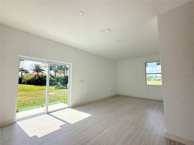 26345 Trinilas Dr, Punta Gorda, FL 33983 - unfurnished room with plenty of natural light, baseboards, and visible vents