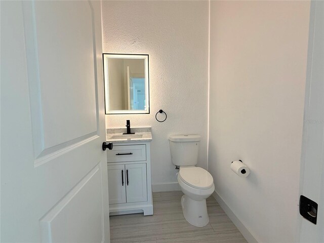 26345 Trinilas Dr, Punta Gorda, FL 33983 - half bath with baseboards, toilet, and vanity