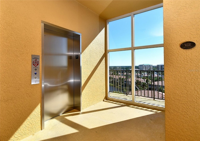 interior space featuring elevator and carpet floors