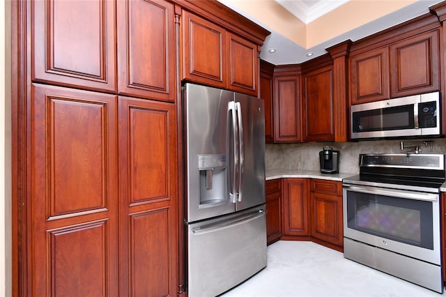 kitchen with stainless steel appliances, tasteful backsplash, and crown molding