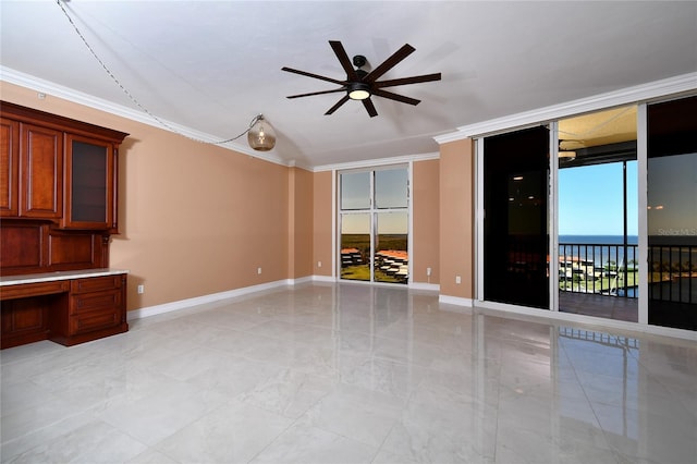 interior space with a water view, ornamental molding, built in desk, and a wealth of natural light