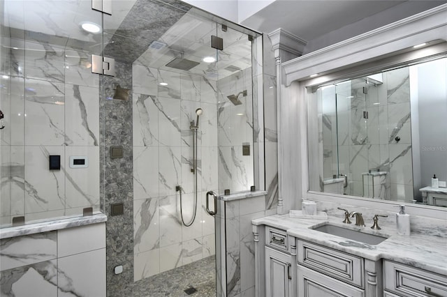 bathroom featuring walk in shower and vanity