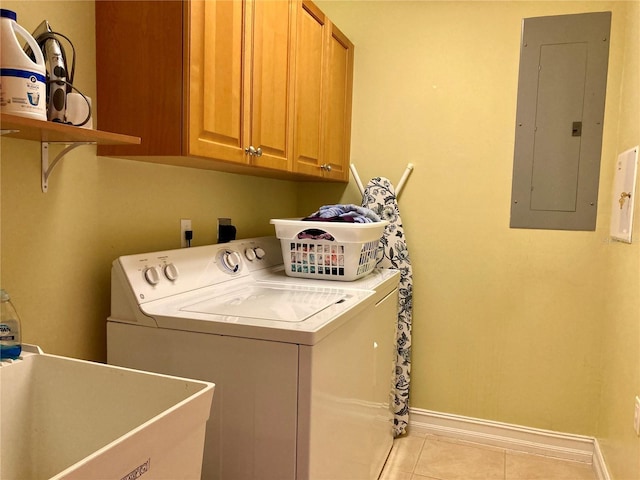 clothes washing area featuring washing machine and clothes dryer, light tile patterned flooring, cabinets, electric panel, and sink