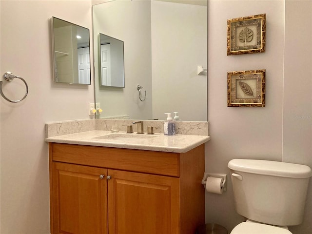 bathroom with toilet and vanity