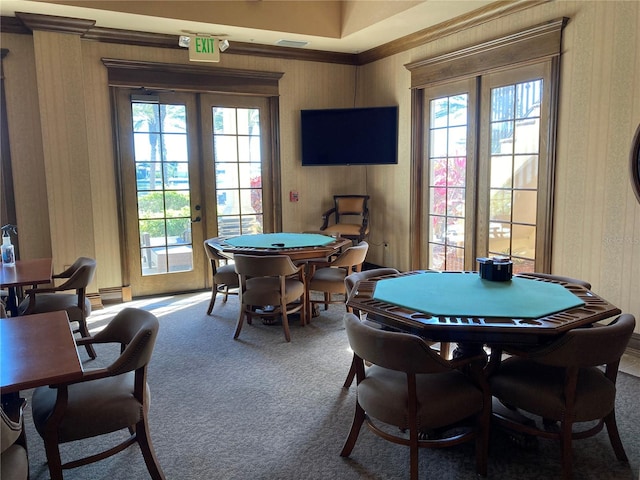 game room featuring ornamental molding, a healthy amount of sunlight, french doors, and carpet flooring