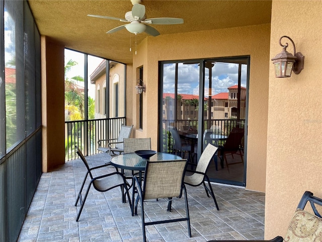 sunroom featuring ceiling fan