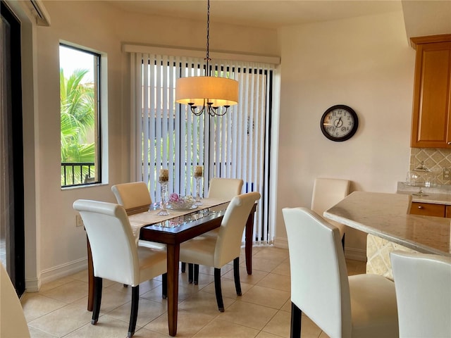 tiled dining area with an inviting chandelier