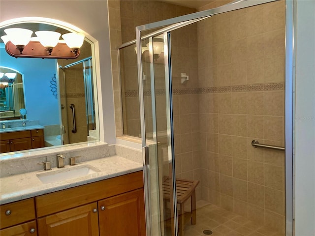 bathroom featuring an enclosed shower and vanity