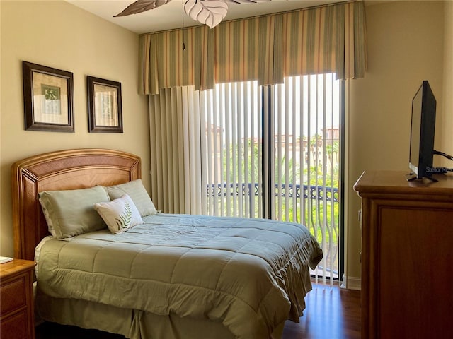 bedroom featuring ceiling fan, access to exterior, and hardwood / wood-style floors