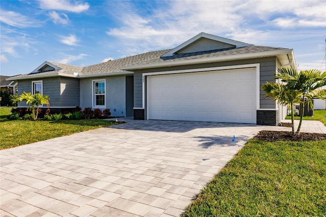 single story home with a garage and a front yard