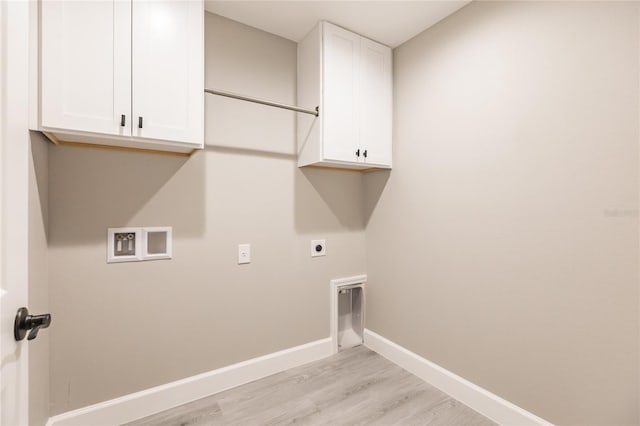 washroom with electric dryer hookup, cabinets, light wood-type flooring, and hookup for a washing machine