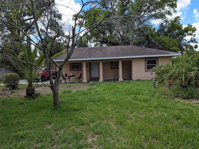 ranch-style house with a front yard and stucco siding