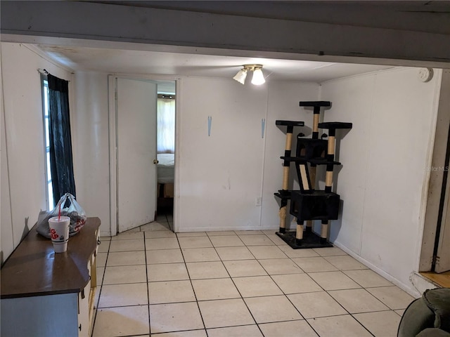 interior space featuring baseboards and light tile patterned floors
