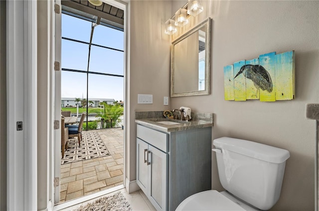 bathroom with tile patterned floors, vanity, and toilet