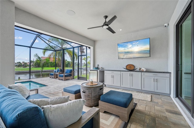 view of patio / terrace with glass enclosure, ceiling fan, and an outdoor hangout area