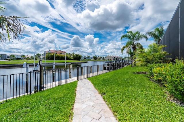 dock area featuring a lawn and a water view