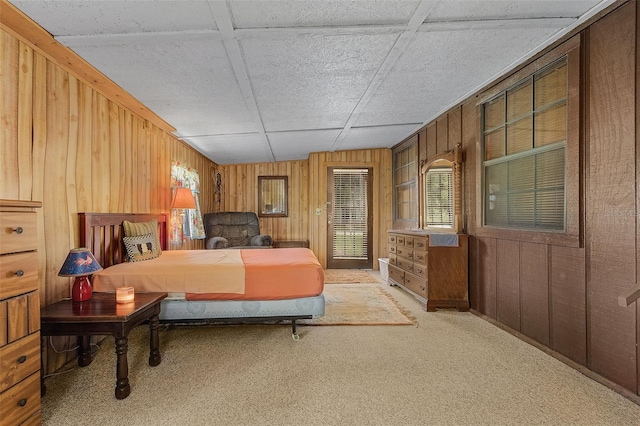 carpeted bedroom featuring wood walls and vaulted ceiling