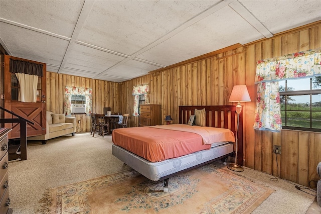 carpeted bedroom with wood walls