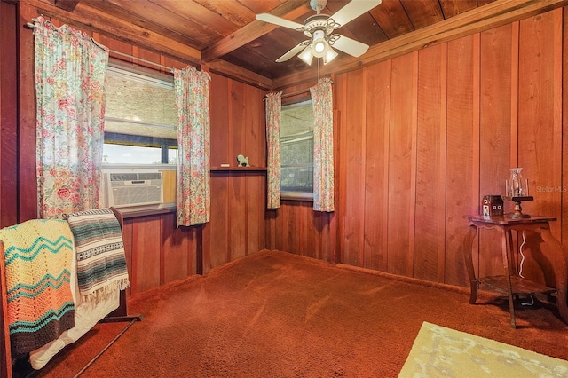 carpeted empty room with wooden ceiling, ceiling fan, and wood walls