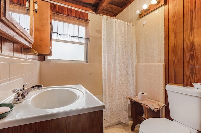 bathroom featuring tile walls, toilet, beam ceiling, wood ceiling, and vanity