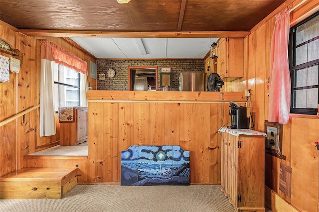 interior space featuring light colored carpet, brick wall, and wooden walls