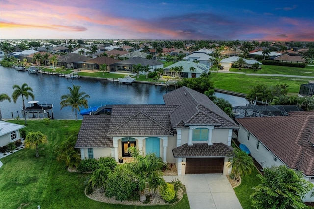 aerial view at dusk with a water view