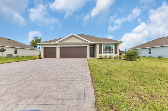 ranch-style house featuring central AC unit, a garage, and a front yard