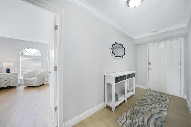 entrance foyer with light hardwood / wood-style floors and crown molding