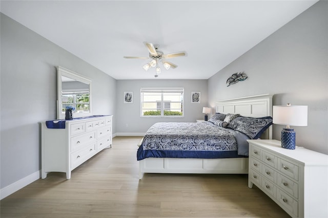 bedroom featuring multiple windows, light wood-type flooring, and ceiling fan