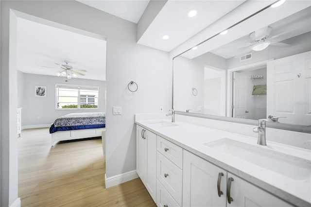 bathroom with hardwood / wood-style floors and vanity