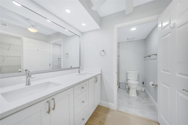 bathroom featuring vanity, hardwood / wood-style flooring, and toilet