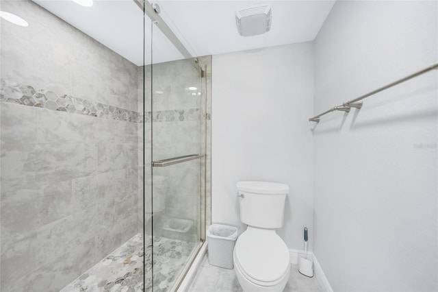 bathroom with toilet and an enclosed shower