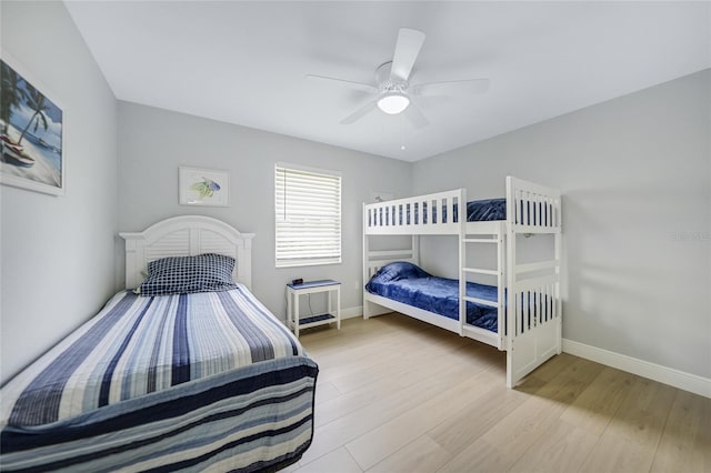 bedroom with ceiling fan and light hardwood / wood-style floors