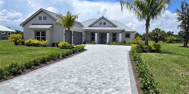 modern farmhouse style home with a front lawn and a garage