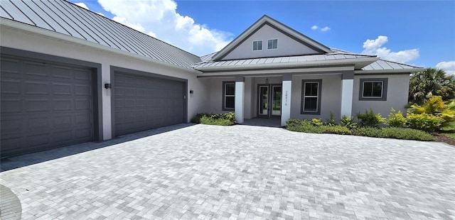 view of front of house featuring a porch and a garage