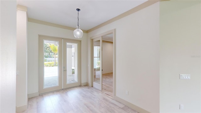 foyer with light hardwood / wood-style flooring and french doors