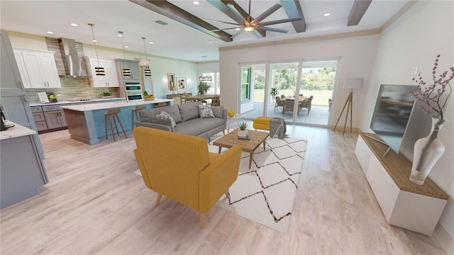 living room with light hardwood / wood-style floors and ceiling fan